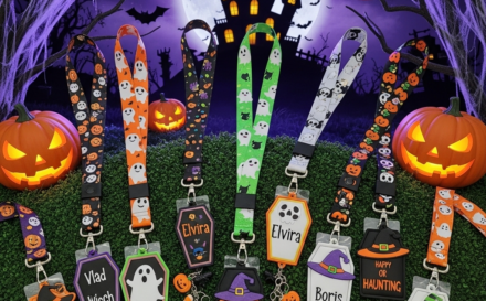 Personalized Halloween-themed lanyards and cardholders on a spooky surface.